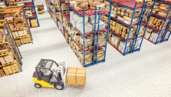 3d render image. industrial machinery at work in a large warehouse full of goods. Industry and logistics concept.