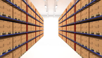 Warehouse shelves filled with large boxes. Retail, logistics, delivery and storage concept. Generic brown containers on racks lined in  two rows. Passage in a big storage house. Distribution facility.